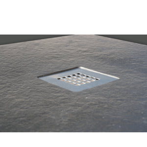 Flair Gemstone Slate Quadrant shower tray with 25mm height and square drainage holes set into textured dark grey slate surface viewed from above in bathroom setting