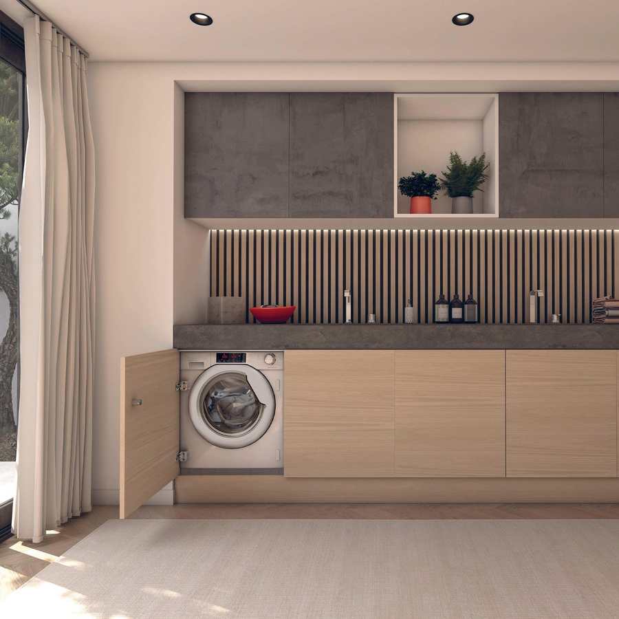 Hoover H-Wash 300 integrated washing machine built into light wood cabinetry in a modern laundry room with dark grey countertop, vertical slat backsplash, upper storage cabinets and potted plants