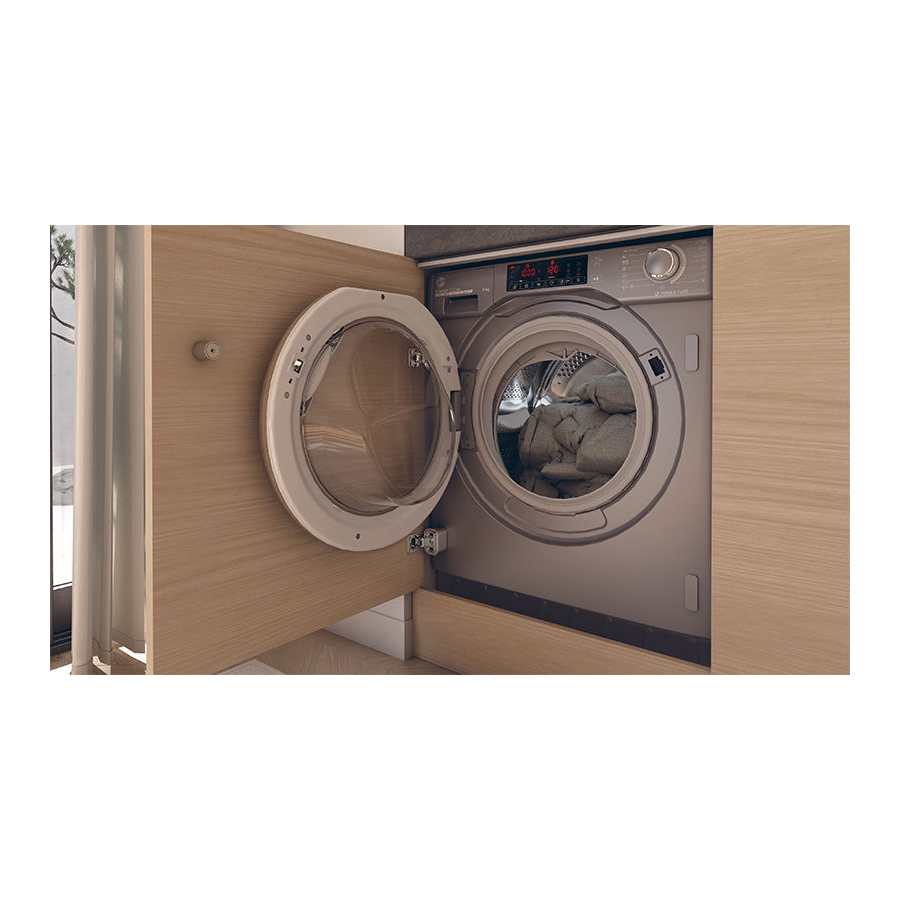 Built-in integrated Hoover H-Wash 300 washing machine with 9kg capacity and 1400 spin in white, shown with open door displaying light grey interior and drum, mounted in light wood cabinetry with digital control panel visible at top
