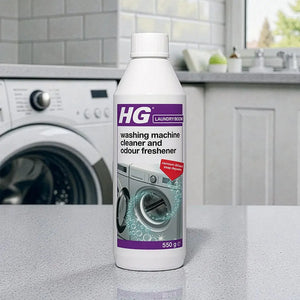 HG Laundry Boom washing machine cleaner and odour freshener 550g bottle displayed on kitchen counter with white washing machine in background
