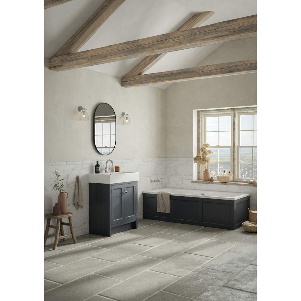 Modern bathroom featuring a black Matt Slate Grey Roper Rhodes Hampton vanity unit with white marble splashback, oval black mirror, exposed wooden ceiling beams, large windows, freestanding bathtub, and grey tile flooring in contemporary farmhouse style