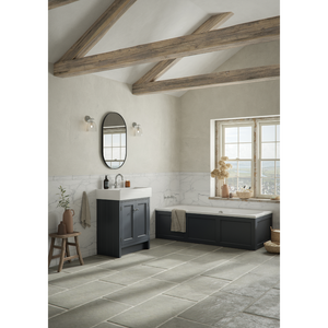 Modern bathroom featuring a black Matt Slate Grey Roper Rhodes Hampton vanity unit with white marble splashback, oval black mirror, exposed wooden ceiling beams, large windows, freestanding bathtub, and grey tile flooring in contemporary farmhouse style