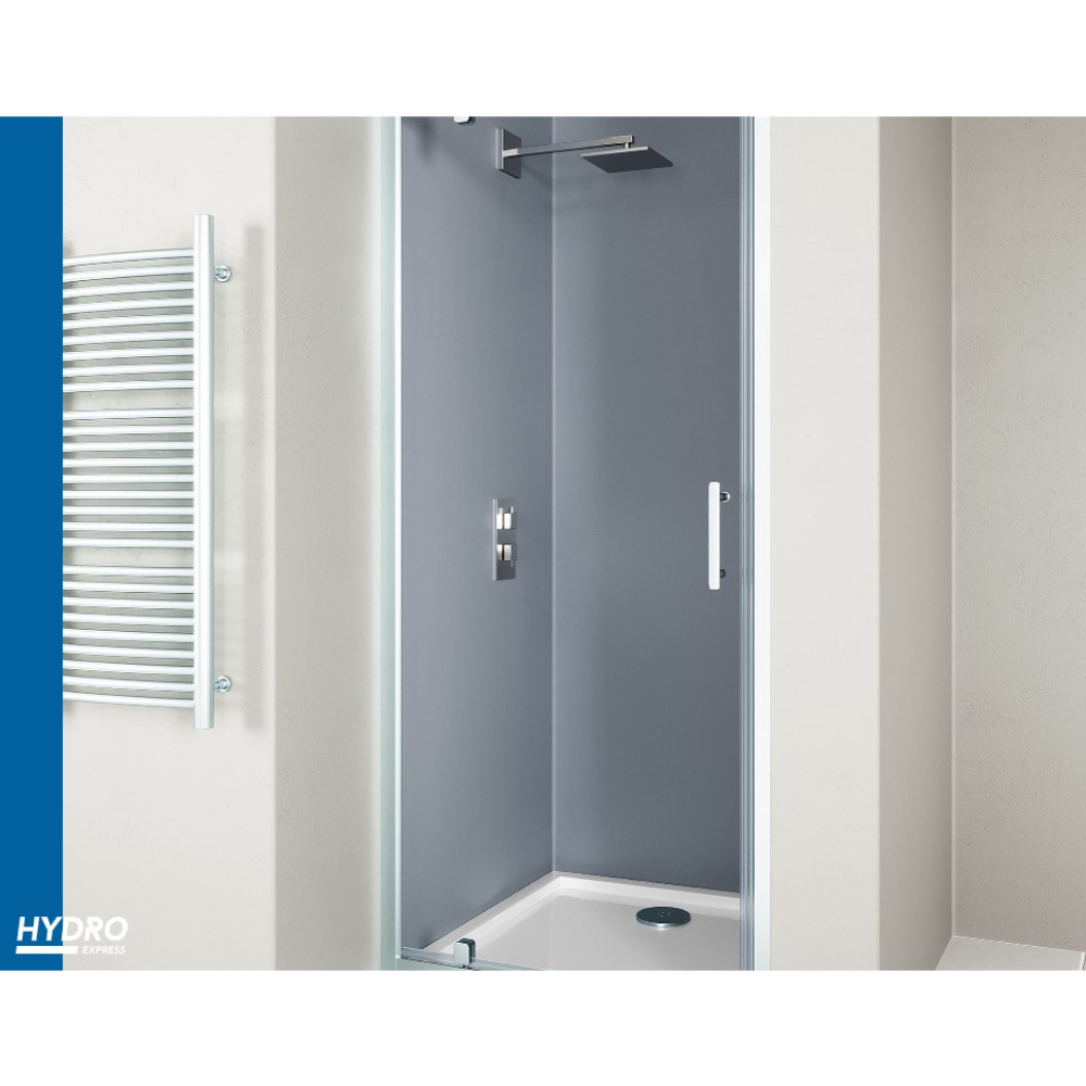 Modern chrome pivot shower door with grey acrylic panels and white frame installed in contemporary bathroom with white walls and towel radiator