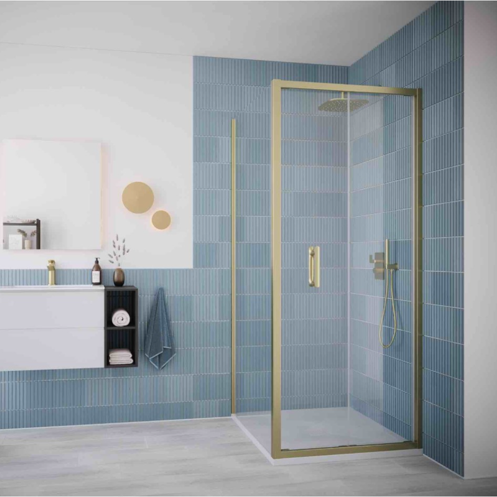 Flair ILI brushed brass bifold shower door installed in modern bathroom with blue vertical tile walls, white vanity, and rainfall showerhead