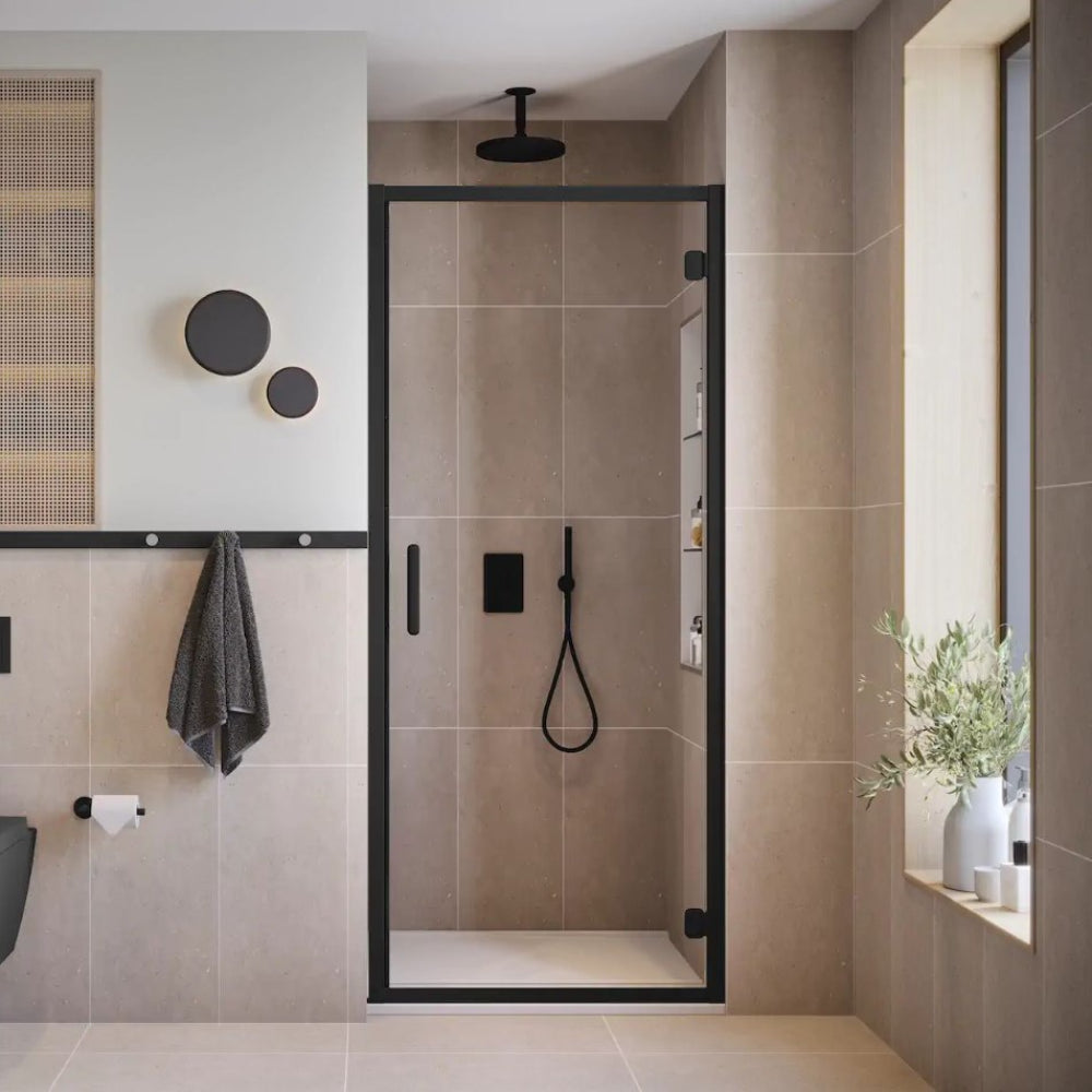Modern matte black framed hinged shower door with clear glass panels installed in a contemporary bathroom with beige and taupe tile walls, black fixtures, and rainfall showerhead