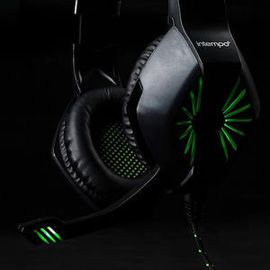 Intempo gaming headset with mic featuring black and gray ear cups with green LED lighting accents, padded headband, and coiled cable against dark background