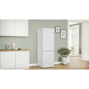 White Bosch Series 4 fridge freezer in modern kitchen with sage green walls, wooden worktops, white cabinetry and potted plant decoration