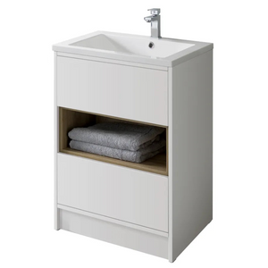 White floor standing bathroom vanity unit with integrated ceramic sink, chrome tap, open oak-effect shelf storing grey towels, and closed white storage compartment below
