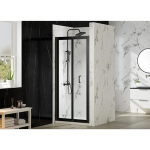 Modern bathroom featuring a Merlyn MBOX bifold shower door with matt black frame and clear glass panels, installed in a marble-effect enclosure with white and grey veining, alongside black marble wall tiles, circular mirror, white sink unit and wooden shelf with toiletries