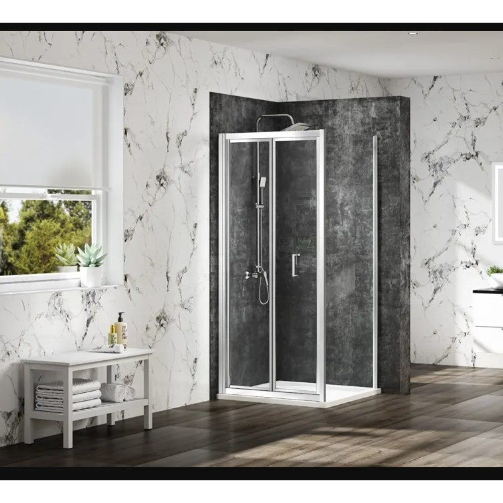 Merlyn MBOX bifold shower enclosure with chrome frame and dark grey textured back panels in modern bathroom with white marble veined walls and dark wood flooring