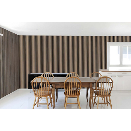 Modern dining room with wooden table, natural wood Windsor chairs, vertical slat acoustic wall paneling in dark wood finish, white ceiling, and contemporary kitchen cabinetry with large window
