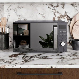 Black Morphy Richards Cassini digital microwave with 20 litre capacity positioned on a marble countertop with veining, surrounded by black ceramic containers and wooden accessories, featuring a digital display panel and control dial on the right side