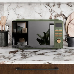 Morphy Richards Cassini 20 litre digital microwave in sage green and black with honeycomb detail, displayed on a marble countertop with black ceramic containers and wooden accessories in a modern kitchen setting