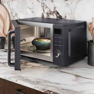 Morphy Richards Cassini Digital Microwave in black with 20 litre capacity, displayed on a marble countertop with open door showing teal bowl of food inside, featuring control panel with digital display and time dial on right side