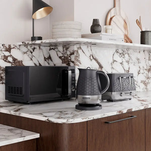 Morphy Richards Cassini Digital Microwave in moonless night black displayed on a marble countertop in a modern kitchen setting with matching black kettle and toaster