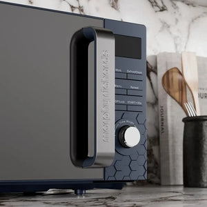 Morphy Richards Cassini Digital Microwave 20 Litre 700W in Outer Space blue with stainless steel handle, featuring control panel with buttons for Defrost/Clock, Menu, Reheat, Stop/Lock and START/+30s, plus Time Weight dial, displayed on marble countertop with kitchen utensils in background