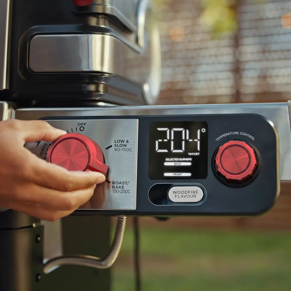 Hand adjusting a coffee machine's temperature control knob with a digital display showing 204 degrees.