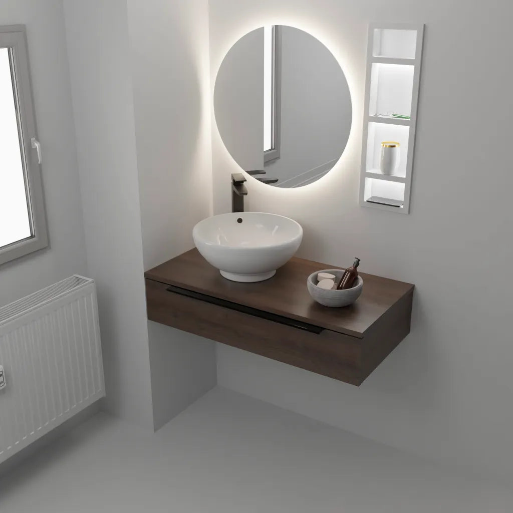 Modern bathroom vanity unit featuring a dark wood wall-mounted cabinet with white ceramic vessel sink, illuminated oval mirror with integrated LED lighting, and matching white storage shelving on white walls