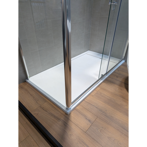 Modern rectangular white shower tray with chrome frame and glass enclosure on wooden floor, Flair Gemstone Slate design with 25mm height