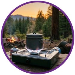 A camping pot on a small portable gas stove outdoors at sunset, with trees and mountains in the background, framed by a purple circular border.
