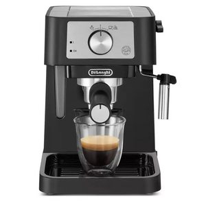 DeLonghi Stilosa black espresso coffee machine with stainless steel portafilter dispensing espresso into a glass cup, featuring rotary dial control panel and drip tray