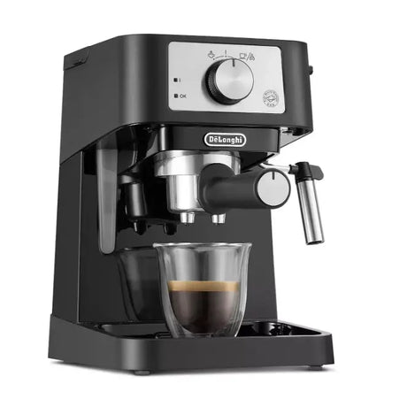 DeLonghi Stilosa black espresso coffee machine with stainless steel portafilter and glass cup, featuring control panel with dial and indicator lights