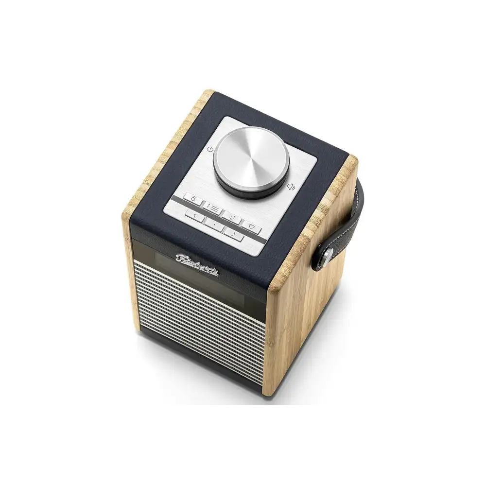 Roberts Rambler Midi DAB+ FM radio with Bluetooth in navy blue and natural wood finish, featuring a silver rotary volume knob, digital display buttons, and carrying handle against a white background