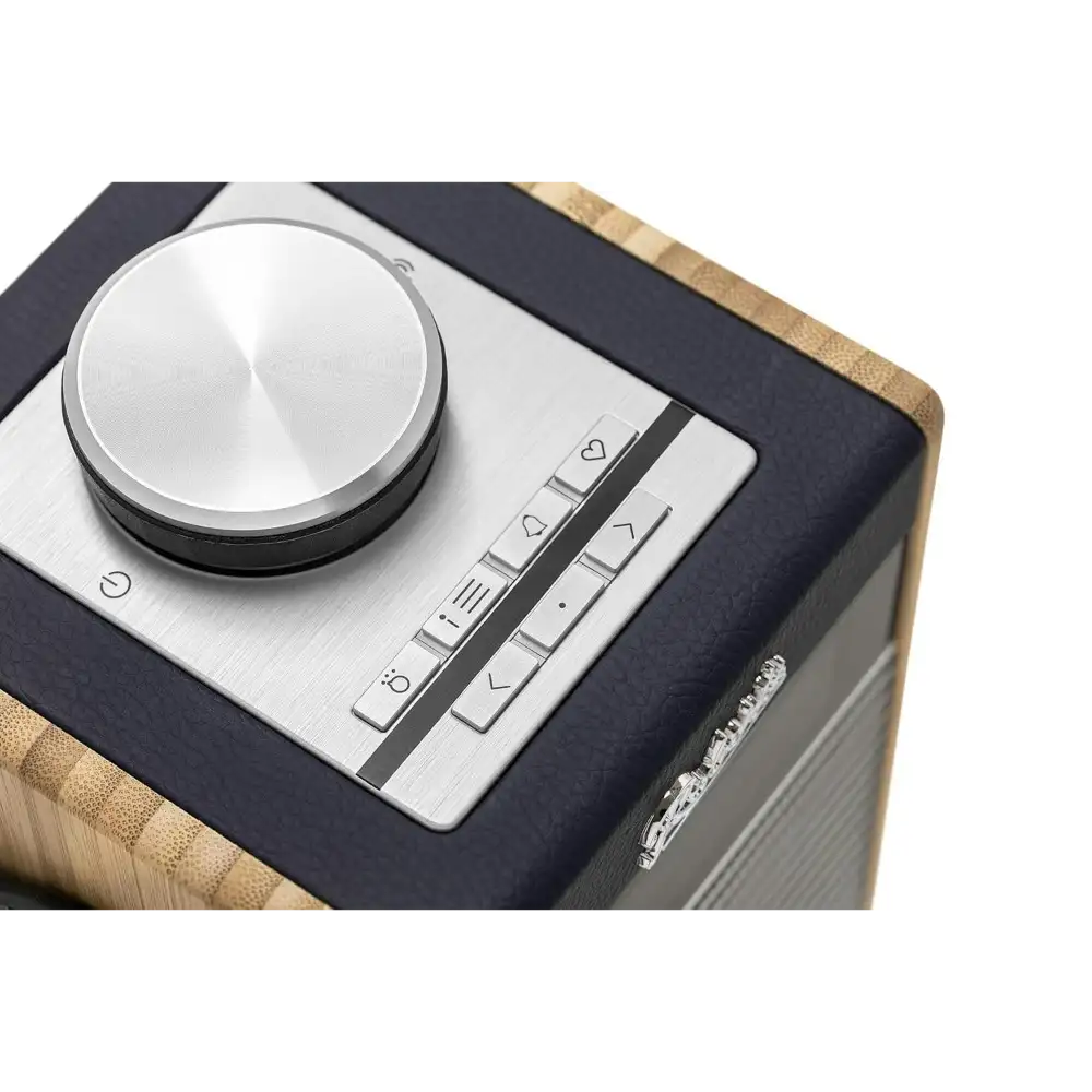 Roberts Rambler Midi DAB+ FM radio with Bluetooth in navy blue featuring a silver brushed metal control panel with large volume knob and button controls, natural wood trim accents on a dark fabric body