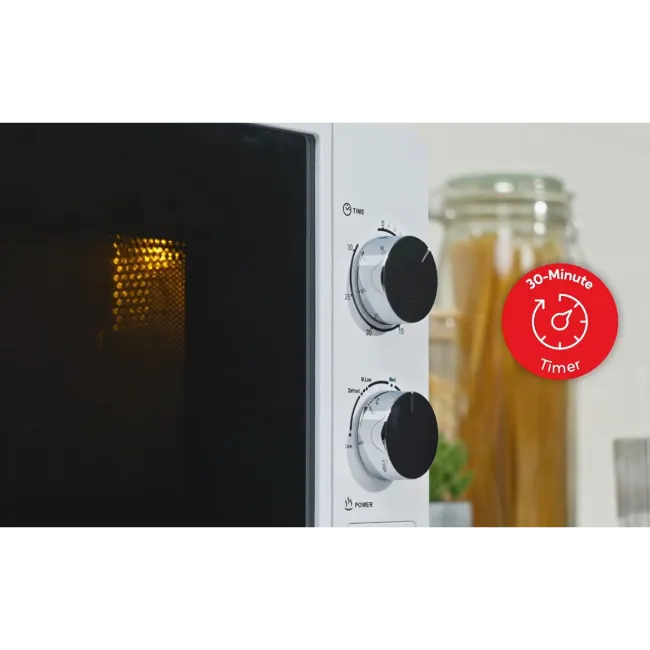 Russell Hobbs white 700W manual microwave with black interior, control dials, and 30-minute timer badge, displayed with pasta jar in background