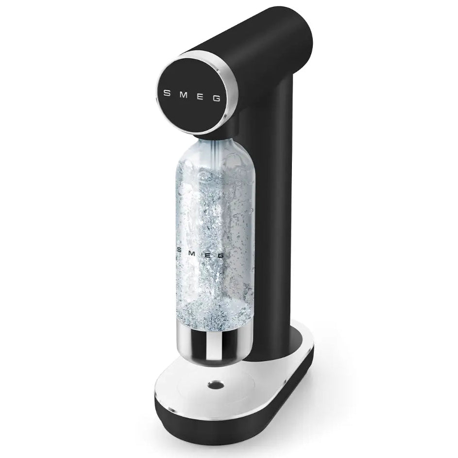 Smeg matte black and white sparkling water maker with CO2 bottle inserted, featuring circular control dial and chrome accents on white base