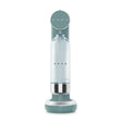 Smeg SKC01EGM sparkling water soda maker in emerald green with stainless steel accents, featuring a cylindrical design with clear water bottle chamber and rounded base