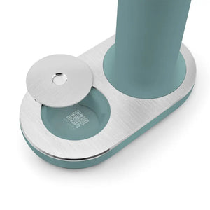 Smeg SKC01EGM sparkling water soda maker in emerald green and brushed stainless steel showing base with two cylindrical chambers and QR code detail