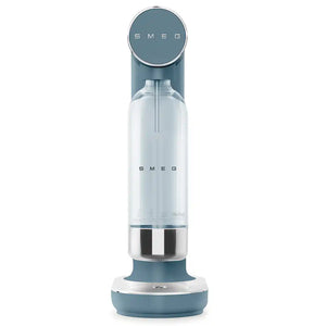 Smeg Sparkling Water Soda Maker in Storm Blue with chrome accents, featuring a clear glass bottle with stainless steel base and teal-colored top and bottom components