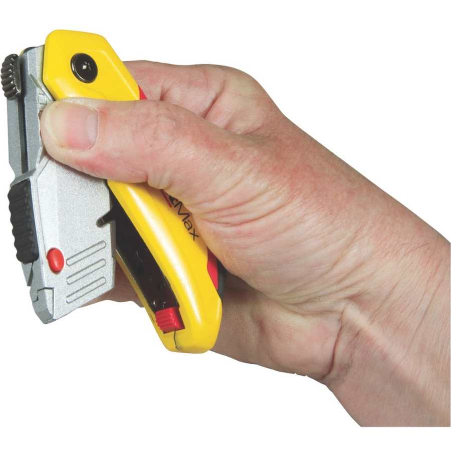 Hand holding Stanley Fatmax retractable folding knife with yellow and red handle, chrome blade housing, and red safety button against white background