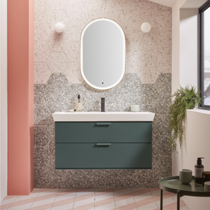 Modern bathroom vanity unit in Derwent Blue with white ceramic basin and oval mirror, surrounded by hexagonal terrazzo tile backsplash in grey and beige tones, featuring wall-mounted sconces and contemporary styling