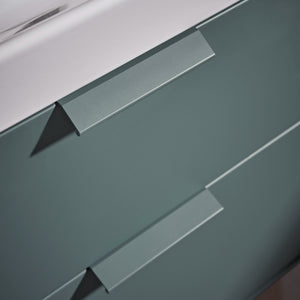 Close-up detail of Roper Rhodes Scheme vanity unit drawer front in Juniper Green with chrome handle and white edge banding showing contemporary minimalist design