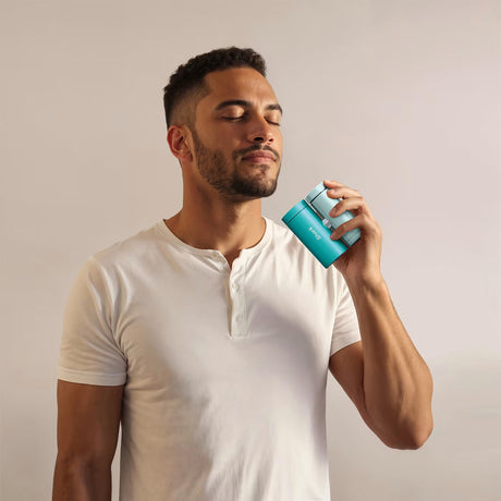 Man holding a blue can against a plain background