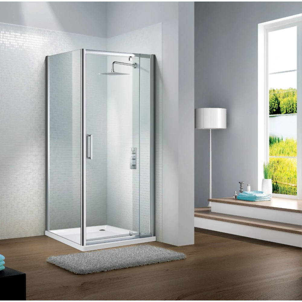 Modern chrome framed pivot door shower enclosure with clear glass panels and white tray on wooden bathroom floor next to window