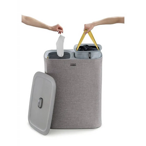 Joseph Joseph Tota 90 litre grey fabric laundry basket with removable dividers and yellow handles, shown with lid removed and compartments open for sorting laundry