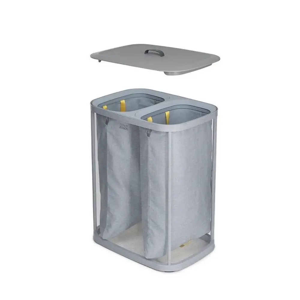 Joseph Joseph Tota 90 Litre grey dual compartment laundry basket with fabric dividers and handles shown open with lid removed