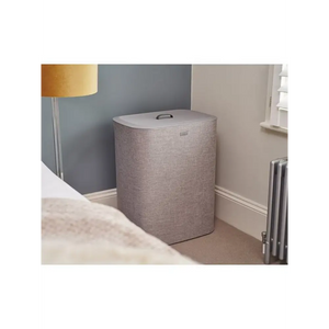 Joseph Joseph Tota 90 litre grey fabric laundry basket with lid and handles in modern bedroom setting