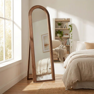 Tara Lane stepped arched floorstanding mirror with natural wood frame in bedroom setting, 40cm x 170cm, leaning against wall beside bed with cream bedding and wooden flooring