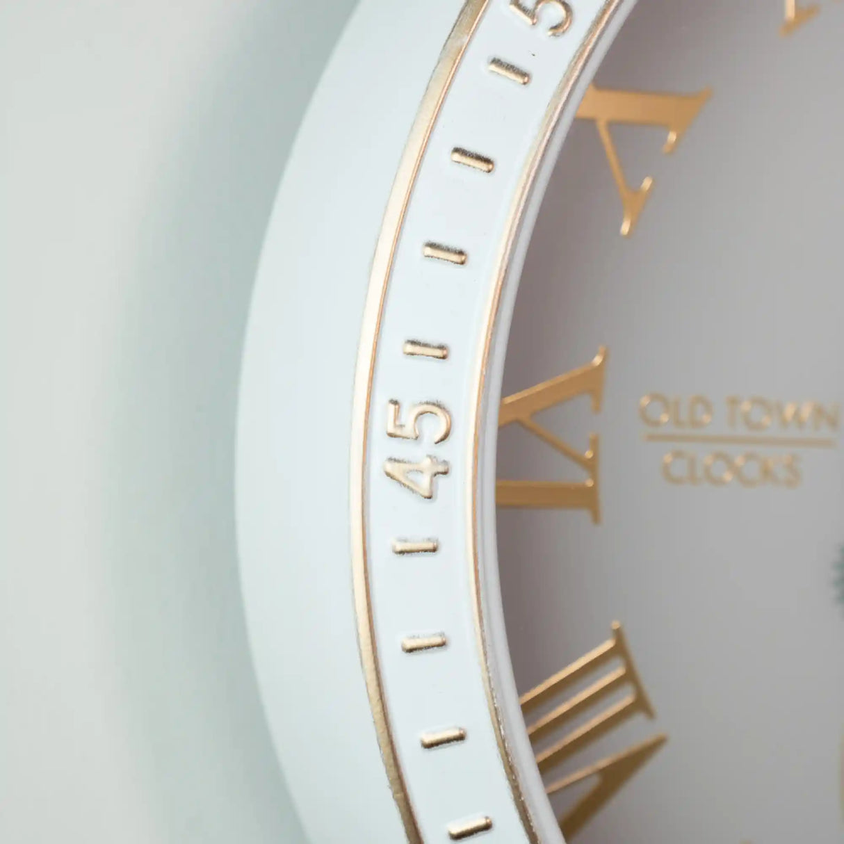 Close-up of Tara Lane Old Town Gears Clock 50cm in ivory with gold numerals and gear details showing the clock face and mechanical design elements