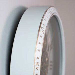 Close-up of Tara Lane Old Town Gears Clock showing ivory face with copper-colored numerals and gear mechanism visible through transparent center, 50cm diameter wall clock in vintage style