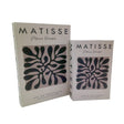 Two cream linen decorative boxes featuring black and dark blue abstract leaf motifs in Matisse style, labeled Matisse Papiers Decoupes Aix en Provence Pavilion de Vendome, displayed in graduated sizes