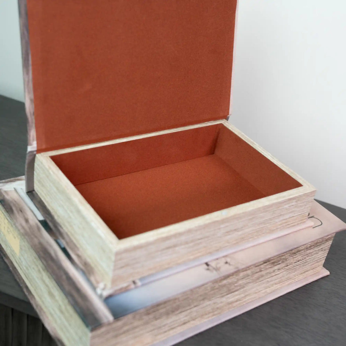 Two wooden book-shaped storage boxes with natural light wood finish and rust-red fabric interior lining, displayed open to show empty compartments, stacked together