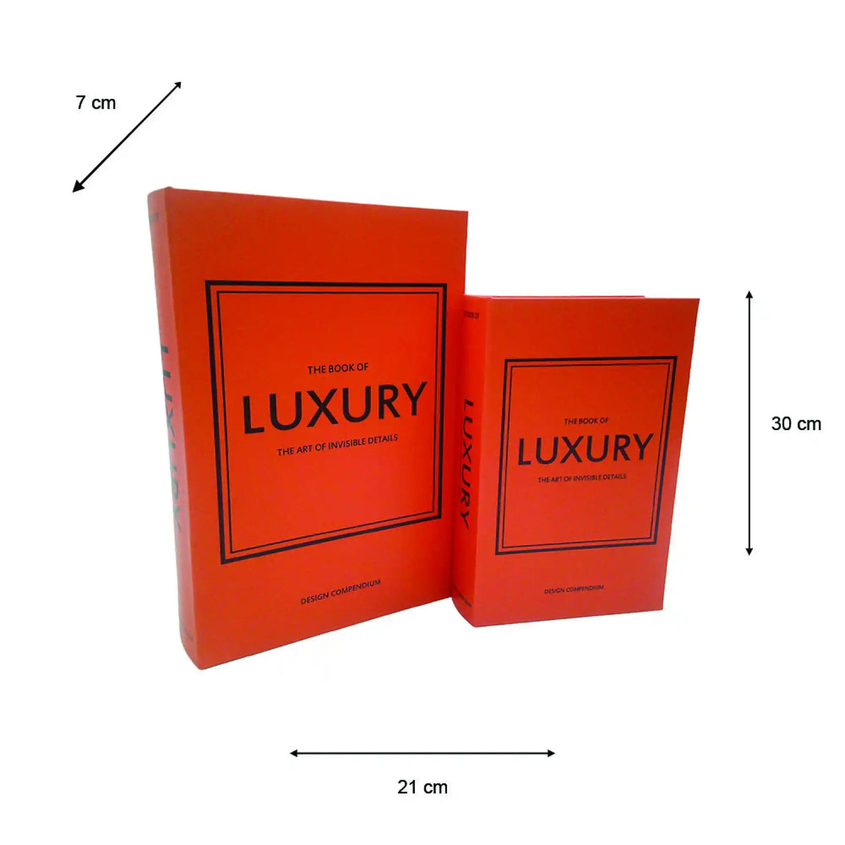 Two red decorative book boxes from the Tara Lane Luxury collection stacked at an angle, featuring black bordered frames with "The Book of Luxury - The Art of Invisible Details" text, measuring 21cm width by 30cm height, with a 7cm depth indicator
