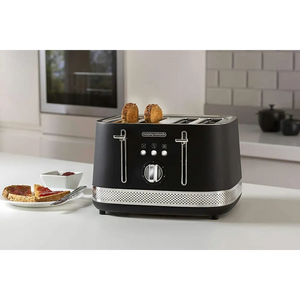 Morphy Richards Illumination black 4 slice toaster with chrome accents on white kitchen countertop, displaying two slices of toasted bread in slots, with toasted bread and jam on plate beside it