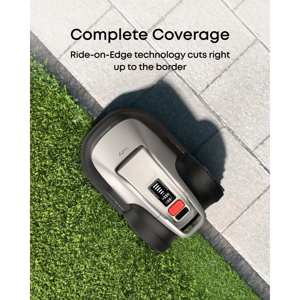 Eufy E18 robot lawn mower shown from above on grass and paved border demonstrating Ride-on-Edge technology for complete coverage, silver and black device with red control button visible