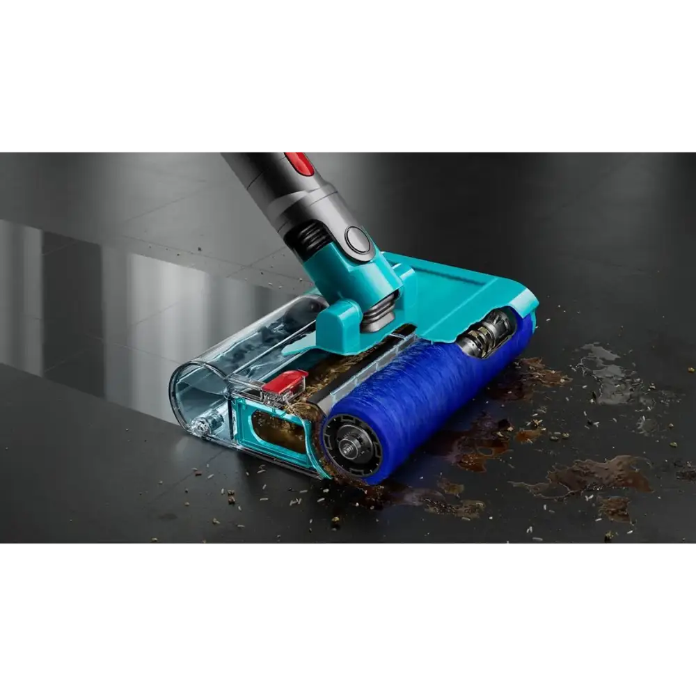 Dyson Cyclone V10 Submarine wet and dry cordless vacuum cleaner with turquoise and blue motorized cleaning head actively removing dirt and debris from dark floor, showing transparent dust chamber and silver metal handle with red power button